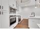 Modern kitchen featuring white cabinets, stainless steel appliances and an open floor plan at 118 Via Roma, Woodstock, GA 30188