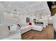 Open-concept living room and kitchen with modern lighting, stainless appliances, and hardwood flooring at 118 Via Roma, Woodstock, GA 30188