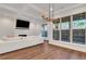 Bright living room with hardwood floors, a white sofa, and natural light at 118 Via Roma, Woodstock, GA 30188
