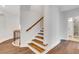 Open staircase features hardwood treads, white risers, and a modern railing at 118 Via Roma, Woodstock, GA 30188