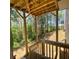 A covered back porch provides a serene outdoor living space with views of the wooded backyard at 211 Serendipity Way, Dallas, GA 30157