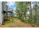 Private backyard with lush greenery and a deck, perfect for relaxing and entertaining guests at 211 Serendipity Way, Dallas, GA 30157