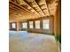 View of a partially finished basement with exposed wooden framing and some windows for natural light at 211 Serendipity Way, Dallas, GA 30157
