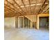 Unfinished basement featuring a framed staircase, exposed ceiling and unfinished concrete floors at 211 Serendipity Way, Dallas, GA 30157