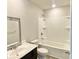 Bathroom with a white vanity, bathtub, and shower combo at 211 Serendipity Way, Dallas, GA 30157
