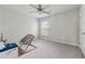 Bedroom featuring a ceiling fan, window, and chair with carpeted floor at 211 Serendipity Way, Dallas, GA 30157