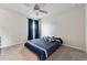 Bedroom featuring a ceiling fan and large window with dark blue curtains at 211 Serendipity Way, Dallas, GA 30157