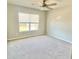 Neutral bedroom features a ceiling fan and a window for natural light at 211 Serendipity Way, Dallas, GA 30157