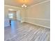 Elegant dining room with hardwood floors, chandelier, and wainscoting, perfect for entertaining at 211 Serendipity Way, Dallas, GA 30157