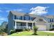 Charming two-story home with a welcoming front porch, two-car garage, landscaped yard and gray and brick exterior at 211 Serendipity Way, Dallas, GA 30157