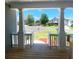 Inviting front porch featuring white columns and railings offering a pleasant view of the neighborhood at 211 Serendipity Way, Dallas, GA 30157