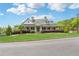 Charming home with a welcoming front porch, well-manicured lawn, and mature landscaping at 211 Serendipity Way, Dallas, GA 30157