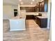 Granite countertops and stainless steel appliances with dark wood cabinets in an open kitchen and living space at 211 Serendipity Way, Dallas, GA 30157