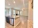 Bright open living space with hardwood floors adjacent to a granite kitchen island at 211 Serendipity Way, Dallas, GA 30157