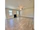 Spacious living room featuring a fireplace, neutral walls, many windows, and light wood-look flooring at 211 Serendipity Way, Dallas, GA 30157