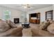 Comfortable living room featuring a fireplace, a ceiling fan, and stylish furniture on wood flooring at 211 Serendipity Way, Dallas, GA 30157