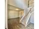 Open living room featuring hardwood floors, staircase with white railings, and recessed lighting at 211 Serendipity Way, Dallas, GA 30157