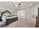 Spacious primary bedroom featuring a trey ceiling, neutral paint, carpet, and a view to the ensuite bathroom at 211 Serendipity Way, Dallas, GA 30157