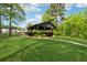 Picturesque outdoor pavilion surrounded by lush greenery and a manicured lawn, perfect for community gatherings at 211 Serendipity Way, Dallas, GA 30157