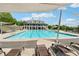 Expansive community pool area with a view of the clubhouse and comfortable lounge seating at 211 Serendipity Way, Dallas, GA 30157