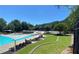 Resort-style pool area with lounge chairs, sun shades, and lush landscaping for relaxation and recreation at 211 Serendipity Way, Dallas, GA 30157