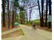 Person cycling on the Silver Comet Trail, with signage for Rambo Trailhead visible at 211 Serendipity Way, Dallas, GA 30157