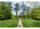 Scenic walking path through lush green spaces leading to a tranquil lake at 211 Serendipity Way, Dallas, GA 30157