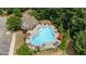 Aerial view showcases a sparkling community pool with lounge seating and surrounding lush landscape at 431 La Perla Dr, Sugar Hill, GA 30518
