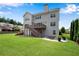 A well-maintained backyard with a deck, stone patio, and lush lawn at 431 La Perla Dr, Sugar Hill, GA 30518