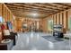 Spacious unfinished basement with framing, sealed concrete floor, and natural light from the windows at 431 La Perla Dr, Sugar Hill, GA 30518