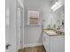 Bathroom features a granite countertop, single sink and custom mirror at 431 La Perla Dr, Sugar Hill, GA 30518