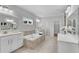 Bright bathroom features double vanities, soaking tub, neutral tile and tile floors at 431 La Perla Dr, Sugar Hill, GA 30518