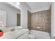 Bathroom with cultured marble vanity and brown-tiled shower and tub at 431 La Perla Dr, Sugar Hill, GA 30518