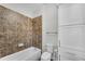 Bathroom with tiled shower/tub, toilet, and custom built-in cabinets at 431 La Perla Dr, Sugar Hill, GA 30518