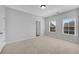 Spacious bedroom with neutral carpet, ample natural light, and a walk-in closet at 431 La Perla Dr, Sugar Hill, GA 30518