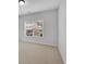 Neutral bedroom with carpet and a window at 431 La Perla Dr, Sugar Hill, GA 30518