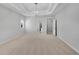 Expansive bedroom with tray ceiling, modern light fixture, and an ensuite bathroom at 431 La Perla Dr, Sugar Hill, GA 30518