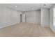 A spacious bedroom with plush carpet and neutral walls, filled with natural light from the window at 431 La Perla Dr, Sugar Hill, GA 30518