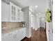 Butler's pantry with granite countertops, cabinetry and tile backsplash at 431 La Perla Dr, Sugar Hill, GA 30518