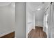 Bright walk-in closet featuring wood floors, shelves, and natural light from the window at 431 La Perla Dr, Sugar Hill, GA 30518