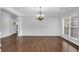Bright dining room features elegant wainscoting, hardwood floors, and a stylish chandelier at 431 La Perla Dr, Sugar Hill, GA 30518