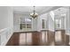 Bright entryway features hardwood floors, wainscoting, and a decorative chandelier at 431 La Perla Dr, Sugar Hill, GA 30518
