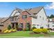 Charming two-story home with lush green lawn, manicured landscaping, and an attached two car garage at 431 La Perla Dr, Sugar Hill, GA 30518