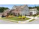 Spacious two-story home with attached garage, lush front lawn, and colorful manicured landscaping at 431 La Perla Dr, Sugar Hill, GA 30518
