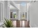 Bright foyer with hardwood flooring, large windows, and view of the entry with decorative glass doors at 431 La Perla Dr, Sugar Hill, GA 30518