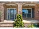 Stone accented front entrance with covered porch, stylish front door, and lush landscaping at 431 La Perla Dr, Sugar Hill, GA 30518