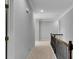 Second story hallway boasts iron banister and carpeted floors at 431 La Perla Dr, Sugar Hill, GA 30518