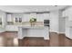 Stylish kitchen with white cabinets, granite countertops, and a central island at 431 La Perla Dr, Sugar Hill, GA 30518