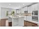 Modern kitchen featuring white cabinets, granite countertops, stainless steel appliances, and a central island at 431 La Perla Dr, Sugar Hill, GA 30518