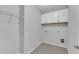 A spacious laundry room featuring tile floors and white cabinets for storage at 431 La Perla Dr, Sugar Hill, GA 30518